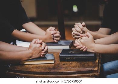 Christian family worship God in home with holy bible on wooden table