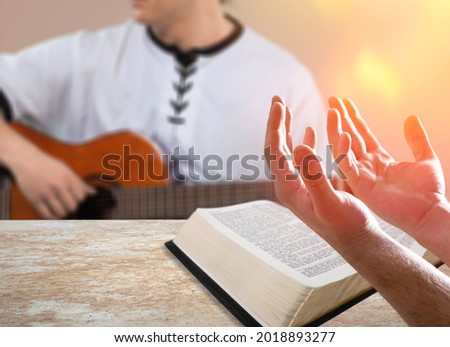 Christian family worship God in-home, with a guitar and the Holy Bible book