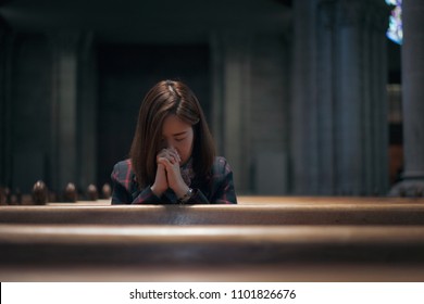 A Christian Girl Is Sitting And Praying With Humble Heart In The Church.