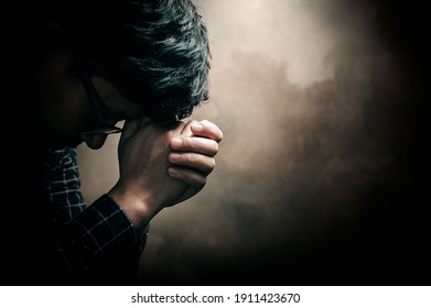 Christian Life Crisis Prayer To God. Man Pray For God Blessing To Wishing Have A Better Life. Man Hands Praying To God With The Bible. Believe In Goodness. Holding Hands In Prayer, Eyes Closed.