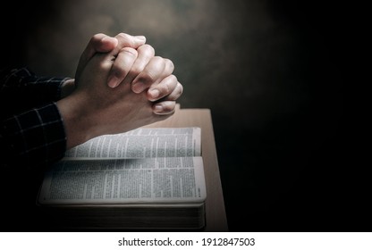 Christian life crisis prayer to god. Man Pray for god blessing to wishing have a better life. man hands praying to god with the bible. believe in goodness. Holding hands in prayer on a wooden table. - Shutterstock ID 1912847503