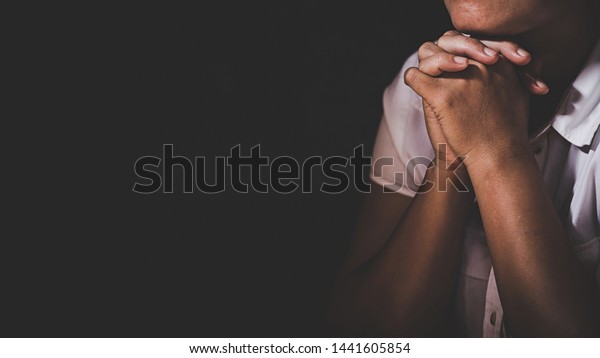 Christian life crisis prayer to god. Woman Pray\
for god blessing to wishing have a better life. woman hands praying\
to god with the bible. begging for forgiveness and believe in\
goodness.