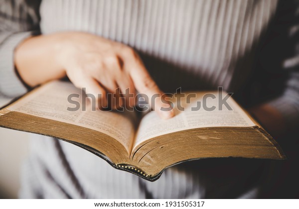 Christian life crisis prayer to god. Woman Pray\
for god blessing to wishing have a better life. woman hands praying\
to god with the bible. begging for forgiveness and believe in\
goodness.