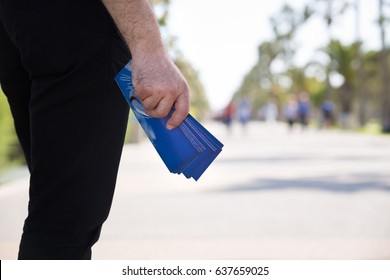 Christian Man Distributing Evangelistic Flyers in The Park - Shutterstock ID 637659025