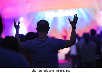 christian music concert with raised hands