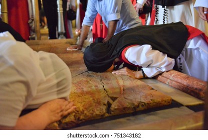 Christian Pilgrims Bow Down In The Holy Grave Church In Jerusalem During Christmas