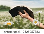 Christian praying with holy bible and flower background