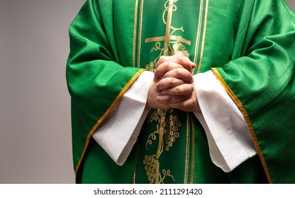The Christian priest holds his hands folded. The priest wears liturgic clothes. - Shutterstock ID 2111291420