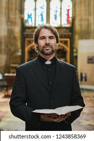 Christian priest standing by the altar