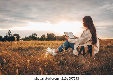 Christian woman holds bible in her hands. Reading the Holy Bible in a field during beautiful sunset. Concept for faith, spirituality and religion. Peace, hope - Powered by Shutterstock