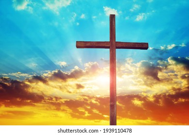 Christian wooden cross at sunset. Religion theme.