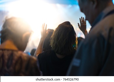 Christian worship with raised hand and pray in the worship concert.