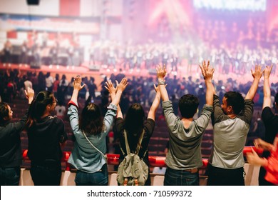 Christian worship with raised hand,music concert - Shutterstock ID 710599372
