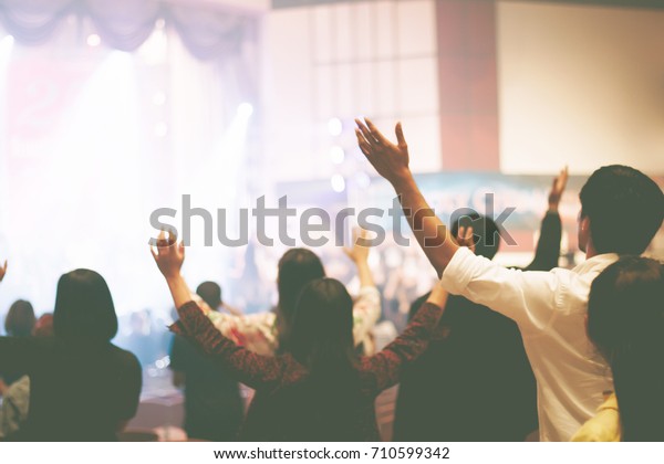 Christian worship\
with raised hand,music\
concert