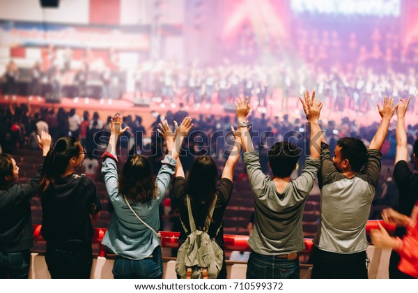Christian worship\
with raised hand,music\
concert