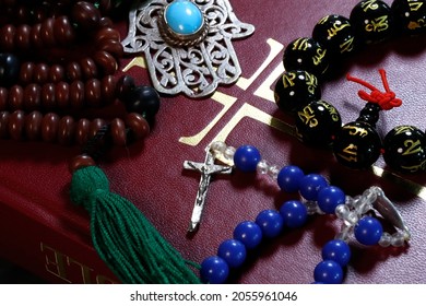 Christianity, Buddhism,  Islam And Judaism. Interfaith Symbols : Bible, Crucifix, Prayer Beads And  Mala. 