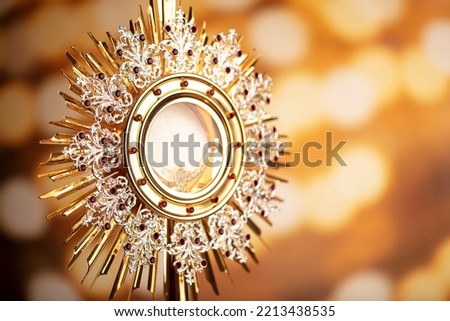 Christianity theme. Golden monstrance on bokeh background