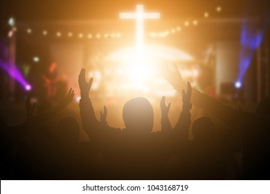 Christians raising their hands in praise and worship at a night music concert. Eucharist Therapy Bless God Helping Repent Catholic Easter Lent Mind Pray. Christian concept background.