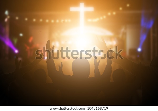 Christians\
raising their hands in praise and worship at a night music concert.\
Eucharist Therapy Bless God Helping Repent Catholic Easter Lent\
Mind Pray. Christian concept\
background.