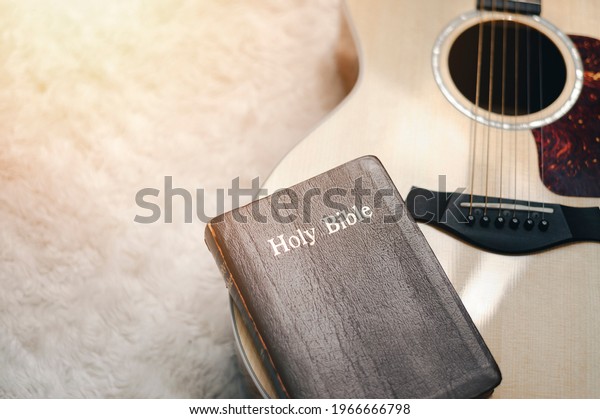 Christians worship God with a guitar with the Holy\
Bible. reading the Bible and sharing the gospel with copy space for\
the word of god.
