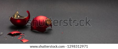 Christmas accident. Red Christmas ball broken, dark gray background, banner, copy space