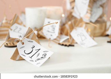 Christmas advent calendar with small gifts on white table, space for text - Shutterstock ID 1858391923