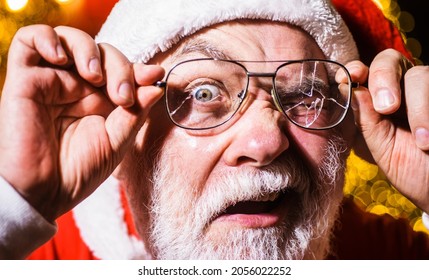 Christmas Advertising. Santa Claus Looking Through Cracked Eyeglasses. Santa Man With Broken Glasses.