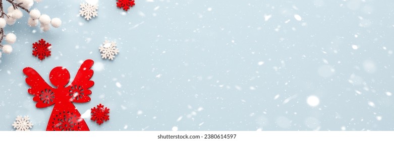 Christmas angel with white and red snowflakes and white berries on a blue background, Merry Christmas and Happy New Year banner, top view, copy space - Powered by Shutterstock