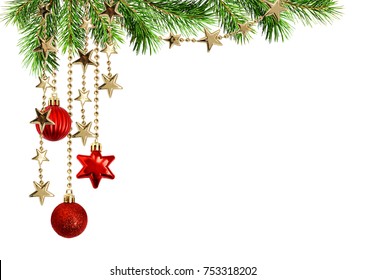 Christmas arrangement with green pine twigs and hanging red decorations isolated on white background
