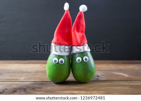 Christmas avocado couple. avocado in christmas hat