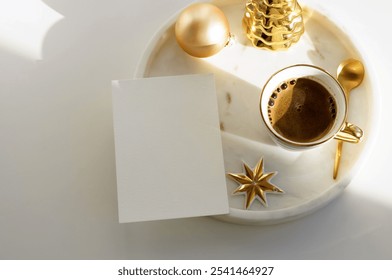 Christmas background with blank greeting card, invitation mockup, cup of coffee and xmas decor on marble tray and white backdrop. Copy space - Powered by Shutterstock