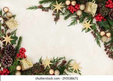 Christmas Background Border With Gold Bauble Decorations, Holly, Mistletoe, Fir And Cedar Cypress Greenery On Old Parchment Paper.