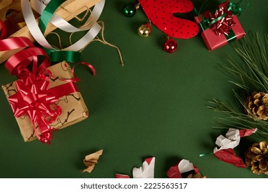 Christmas background with copy advertising space. Beautiful gifts with wrapping materials, decorative tapes, rope and tied bows on a green surface. Boxing Day. Packing presents. Mockup. Festive mood - Powered by Shutterstock