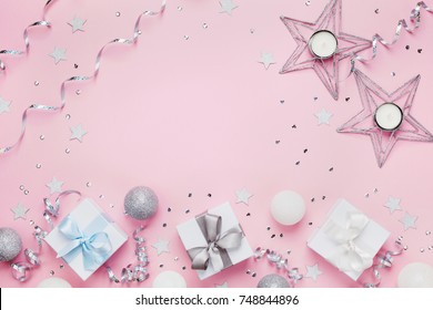 Christmas Background With Copy Space For Greeting Text. Gift Boxes And Decoration On Pink Table Top View. Flat Lay.