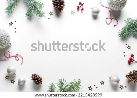 Christmas Background. Christmas decor, pine cones, fir branches, red berries and ornaments on white background, top view, copy space.