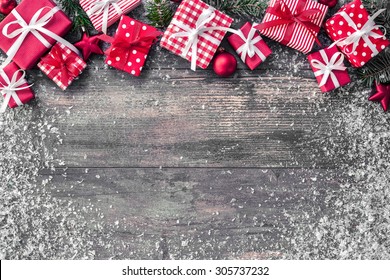 Christmas background with decorations and gift boxes on wooden board - Shutterstock ID 305737232