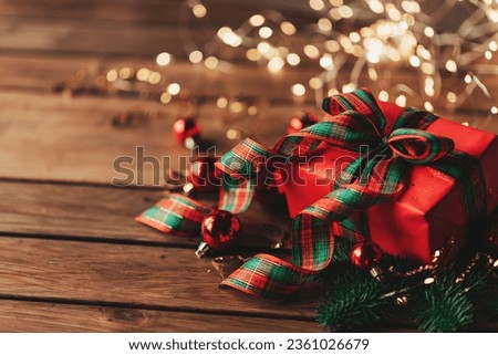 Christmas background with decorations and red gift boxes on wooden board with copy space