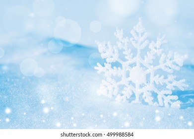 Christmas background with decorative snowflake on brilliant snow