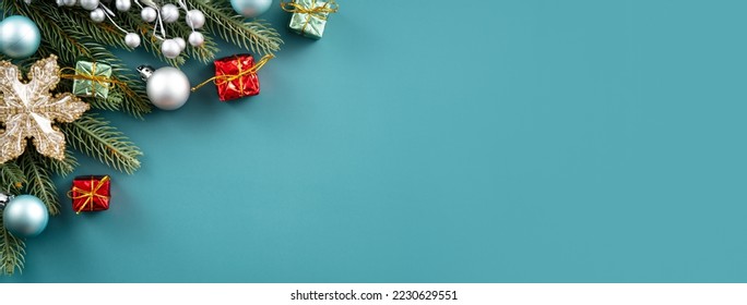 Christmas background design concept, holiday decoration ornament composition with Christmas tree branch, golden bell with copy space isolated on green table. - Shutterstock ID 2230629551