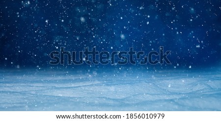 Christmas background with falling snow, selective focus. Beautiful Winter night landscape. Nature Winter background with Copy Space for design.