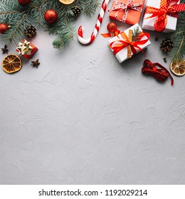 Christmas background with fir branches, decorations/figures of angel, houses,heart, snowflakes/a gift boxes, cinnamon sticks,dry lemon,pine cones,artificial berries/ Space for text - Powered by Shutterstock