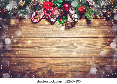 Christmas background with fir tree and decoration on dark wooden board