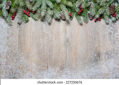 Christmas background with fir tree on old wooden board - Powered by Shutterstock