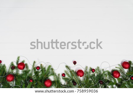 Christmas background frame top view on white wooden plank table background with copy space around products. Decorations isolated on white. Horizontal composition.