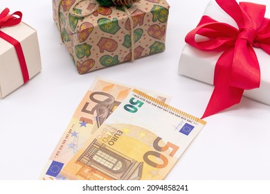 Christmas background with gift boxes and 50 euro money. The concept of preparation for winter holidays. It is time to buy gifts. Festive layout