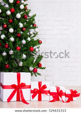 christmas background gift boxes under decorated christmas tree over brick wall - Decorative Christmas Boxes christmas background gift boxes under decorated christmas tree over brick wall - Decorative Christmas Boxes