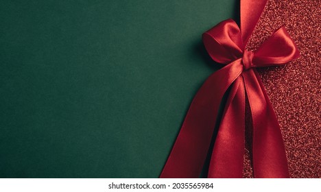 Christmas background. Gift shiny card, certificate or texture gift box with red ribbon bow. New year, christmas or winter sale concept. Top view, flat lay, copy space, banner