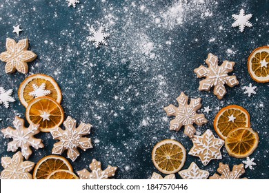 Christmas background with homemade gingerbread cookies on blue table, copy space. Festive food, New Year celebration traditions - Powered by Shutterstock