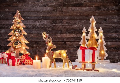 Christmas background with illuminated moose and christmas tree. Dark wooden background with free space for text. Celebration of christmas