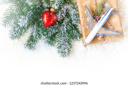 Christmas Background On The Theme Of Travel. The Plane Symbolizes The Gift Of The Journey. Selective Focus. Holiday